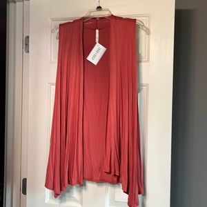 Women’s tunic length sleeveless cardigan/vest.